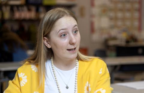 Teacher talking with students at a table